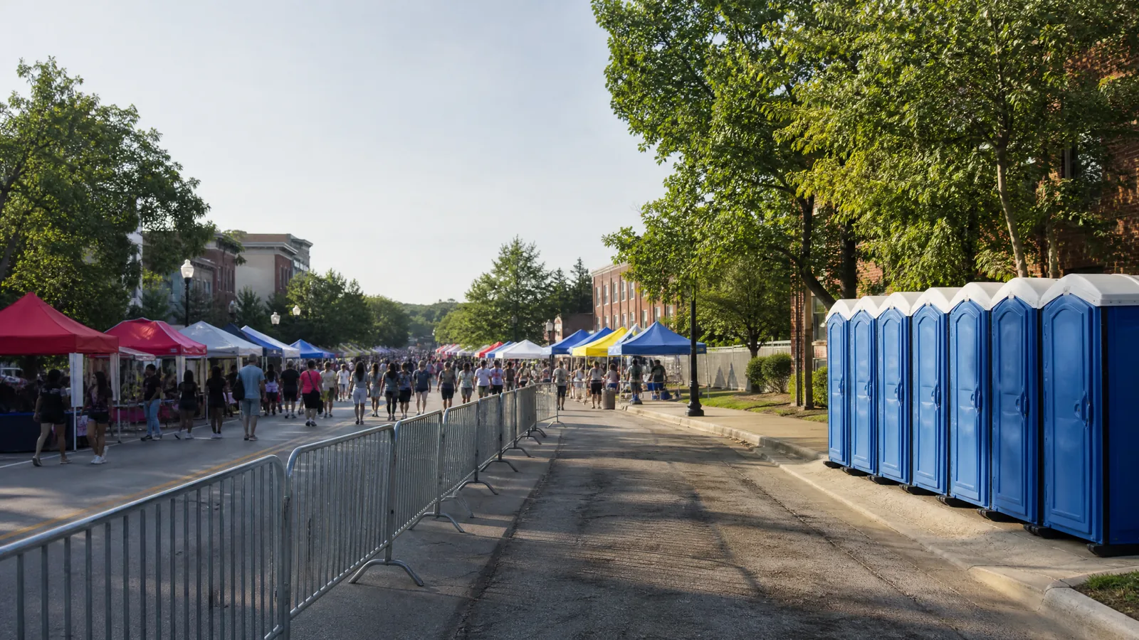 Portable restrooms positioned along an organized neighborhood festival service lane.